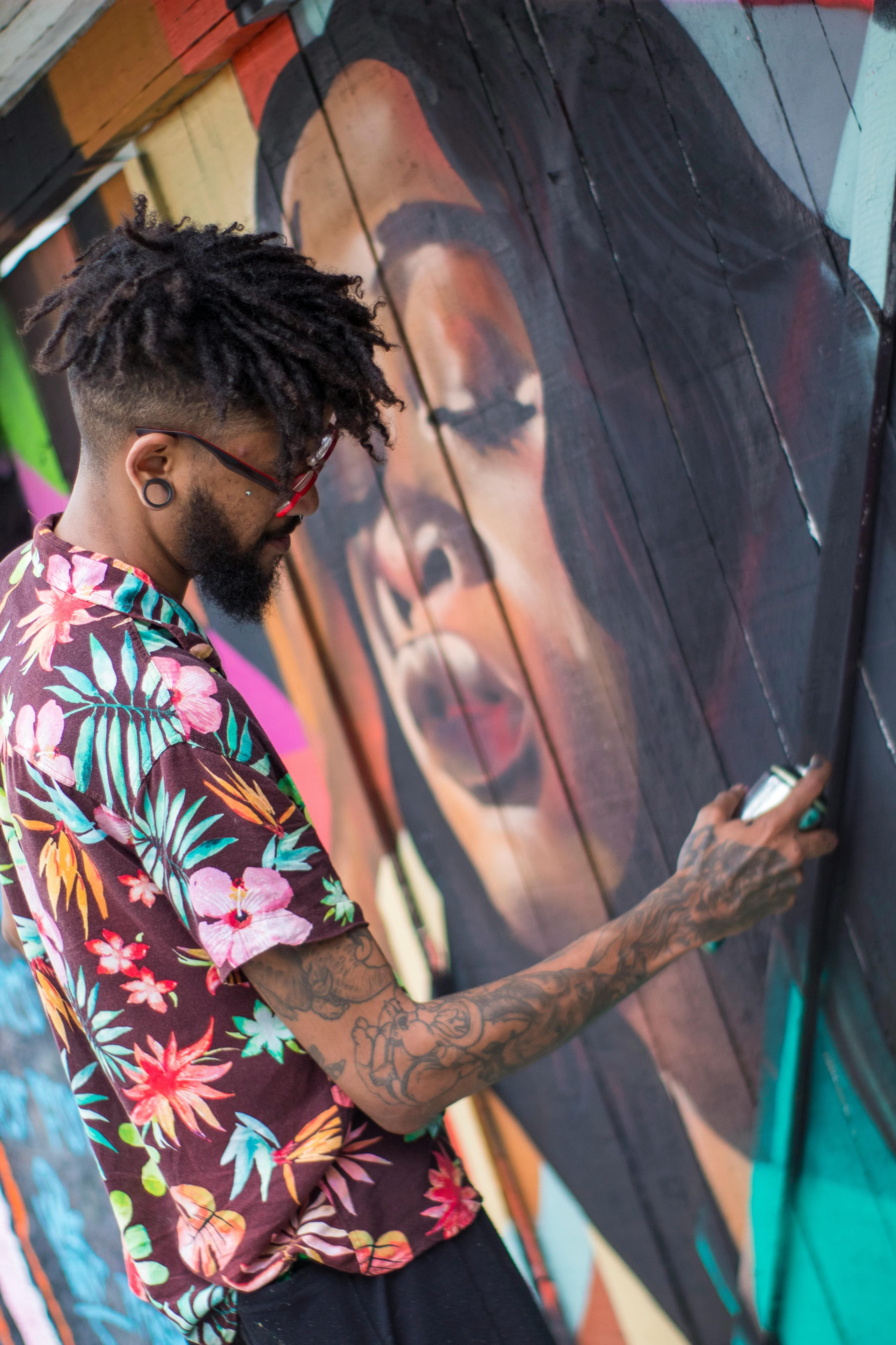 Artist painting a large mural