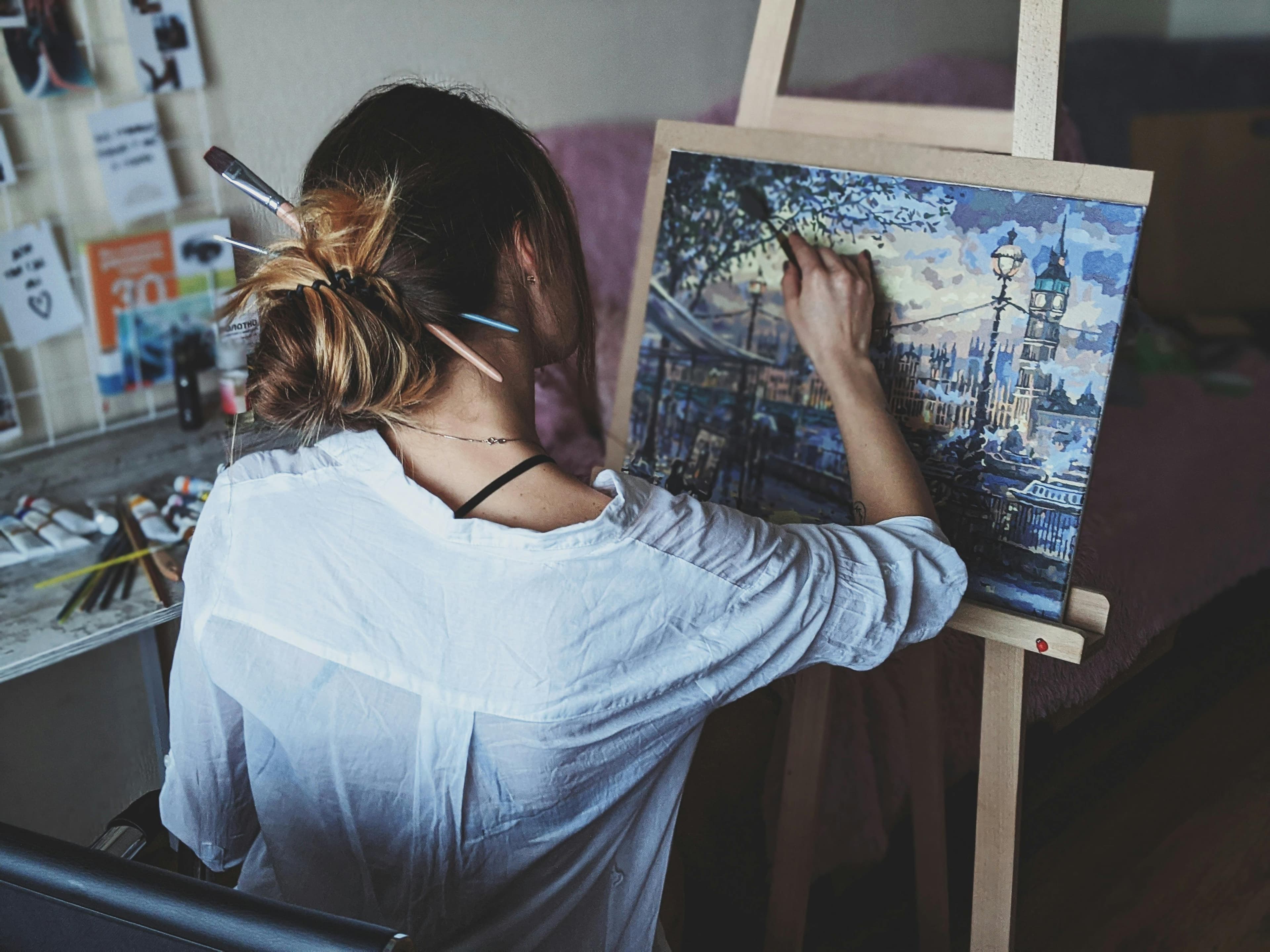 Artist painting at an easel